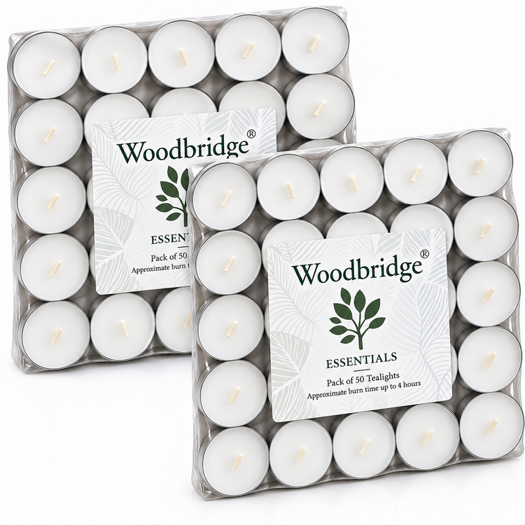 Two clear plastic packages of Woodbridge Essentials tea lights, each containing 50 white round tealight candles, shown on a white background.
