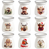 Nine white ceramic scented oil burners arranged in a 3x3 grid, each decorated with a different cute animal illustration including a hedgehog, cow, buffalo, chameleon, deer, snowy buffalo, gingerbread man, robin, and rabbit.