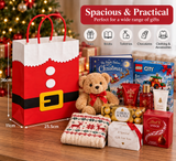 A Christmas-themed gift set arranged on a wooden table in front of a blurred Christmas tree. The set includes a large red and white Santa gift bag with black trim, a brown teddy bear, LEGO toy boxes, Ferrero Rocher chocolate, Lindt chocolate, a knitted sweater, and gift cards, with a red text banner at the top showing product features and dimensions.