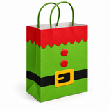 An elf-themed paper gift bag with green handles, featuring a bright green body, a red top section, a black belt, and a yellow buckle detail, shown on a plain white background.