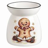 A white ceramic oil burner with a festive gingerbread man illustration on the front, featuring a black rim and gold star accents.