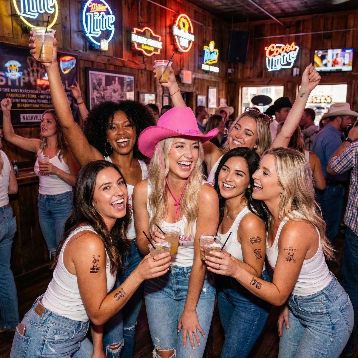 Group of women celebrating in a bar with neon signs and drinks.