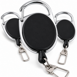 Three retractable badge reel keychains with oval black faces and shiny silver metal carabiners and key rings, arranged on a clean white background.