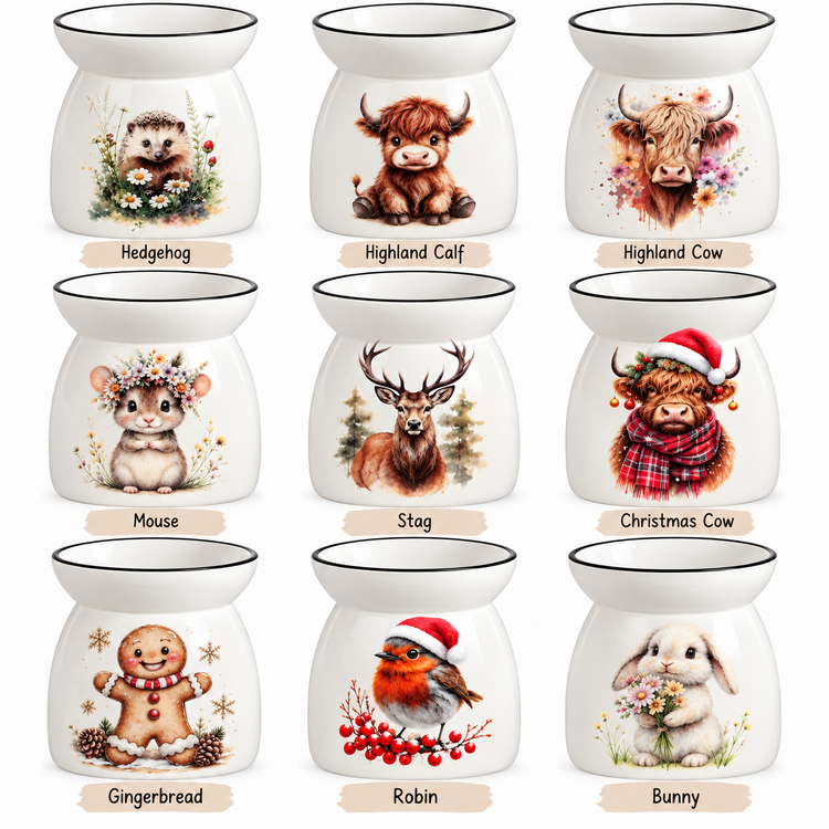 Nine ceramic wax melts or diffusers are arranged in a 3x3 grid on a white background, each with a different animal illustration and a beige label underneath. The animals include Hedgehog, Highland Calf, Highland Cow, Mouse, Stag, Christmas Cow, Gingerbread, Robin, and Bunny.