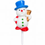 A snowman-shaped lollipop on a white stick, featuring a white body, a blue top hat, red boots and nose, green buttons, and a gold bow tie, isolated on a white background.