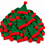 A pile of small plush Christmas elf hats in green and red, each with a red pom-pom, photographed on a clean white background.