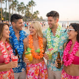 Group of friends on a beach with tropical drinks and leis