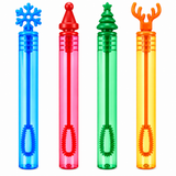 Four colorful bubble wand tubes on a white background, each with a different holiday-shaped top: a blue snowflake, a red Santa hat, a green Christmas tree, and an orange reindeer antler. The tubes are translucent and come in blue, pink, green, and yellow.