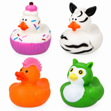 Four animal-shaped rubber ducks arranged in a 2x2 grid on a white background: a cupcake duck with pink frosting and sprinkles, a zebra duck, an orange duck with a pink mohawk, and a green owl duck.