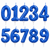 A set of glittery blue number candles shaped like the digits 0 through 9, arranged in two rows on a plain white background.