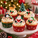 Six decorated Christmas cupcakes on a white marble cake stand, with festive holiday decorations, a blurred Christmas tree, and lights in the background.