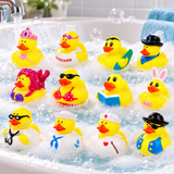 Twelve yellow rubber duck toys with various colorful cartoon outfits and accessories, arranged in a bubble-filled bathtub with running water.