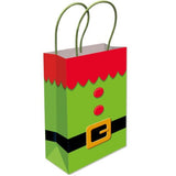 A festive elf-themed gift bag with a bright green body, red scalloped trim, a black belt, and a gold buckle detail, complete with green paper handles on a white background.