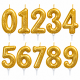 Set of ten gold glitter number candle toppers from 0 to 9, arranged in two rows on a plain white background.