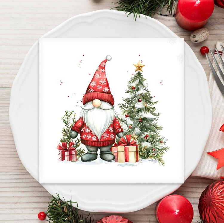 Napkin with a Christmas gnome design on a white plate with festive decorations.