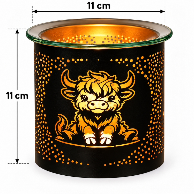 A black cylindrical candle holder or diffuser with a cartoon Highland cow design and orange-gold cutout dots, shown on a white background with 11 cm height and top diameter measurement annotations.