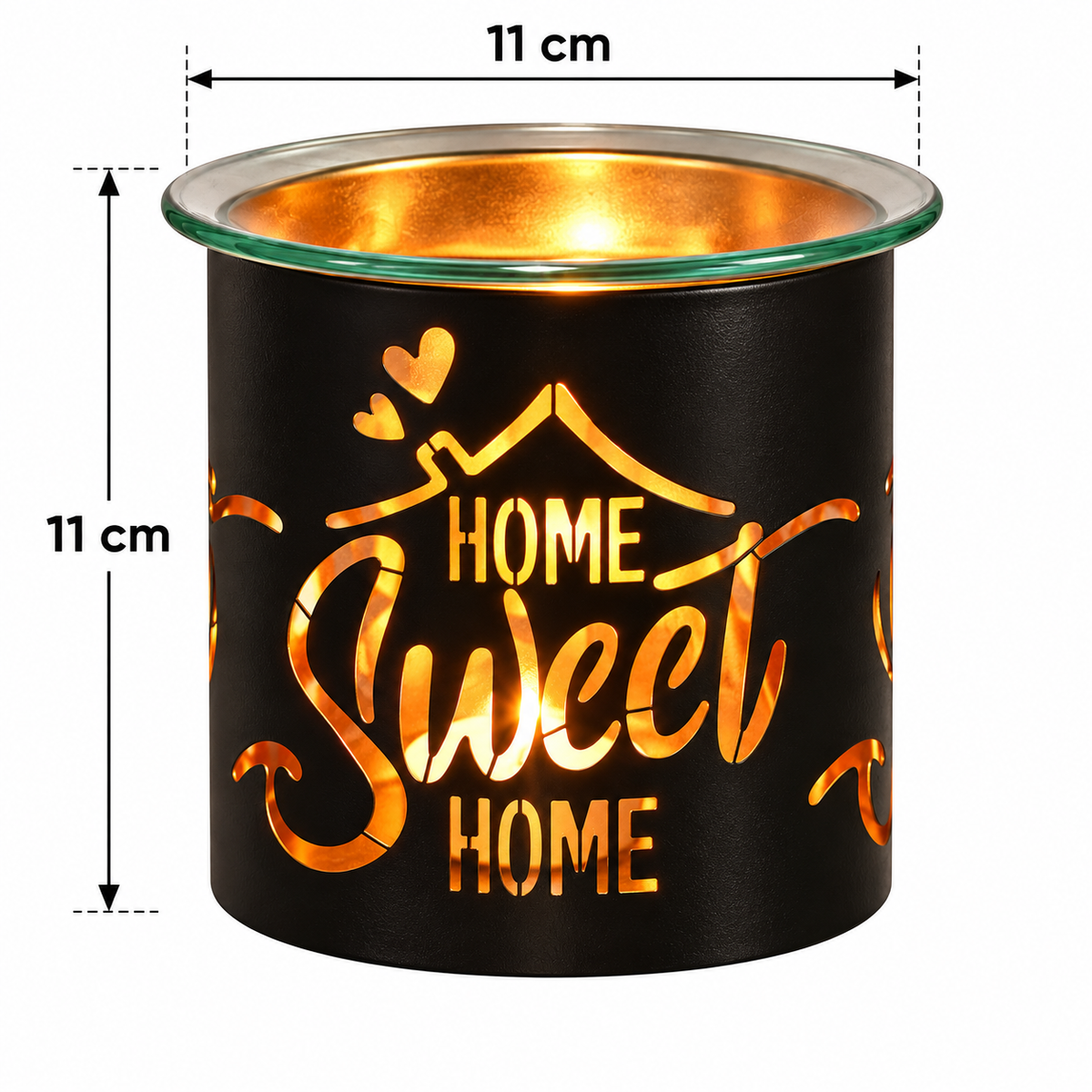 A black cylindrical wax warmer with a glass rim, glowing with warm light inside. The front features a cutout design that reads 'HOME Sweet HOME' in warm orange-gold lettering.