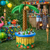 Inflatable palm tree cooler with bottles in a garden setting with people and decorations.