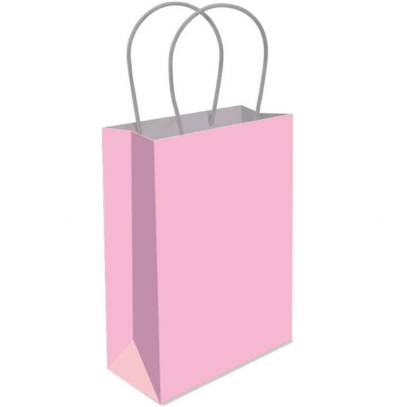 Pink paper gift bag with white handles on a white background