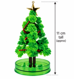 A small artificial Christmas tree with a gold star topper, red berry garlands, and a green round base, shown on a white background with a height measurement marker indicating 11 cm tall.