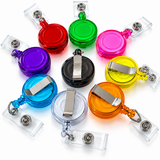 A set of retractable badge reel pens in multiple colors, including red, green, pink, purple, black, yellow, blue, orange, and clear, arranged on a white background.