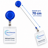 Blue retractable badge reel with clear ID holder shown in two positions on a white background, with text noting it extends up to 70 cm (27.5 inches).