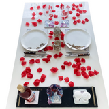 Red rose petals on table for date night