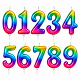 A set of ten inflatable number candles from 0 to 9, featuring a vibrant rainbow gradient with a glossy finish, shown on a plain white background.