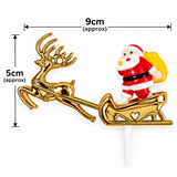 Gold Christmas Santa Claus in a sleigh cake topper with dimension markings showing 9cm width and 5cm height, on a white background.