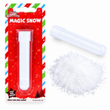 A package of 'Magic Snow' by Henbrandt Ltd, showing the red and green holiday-themed blister card with the white plastic tube inside, a second empty white tube, and a pile of white crystalline fake snow on a clean white background.