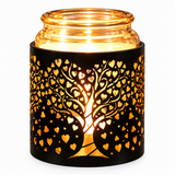 A black metal candle holder with a laser-cut tree of hearts design, illuminated from within by a warm yellow light, set against a plain white background.