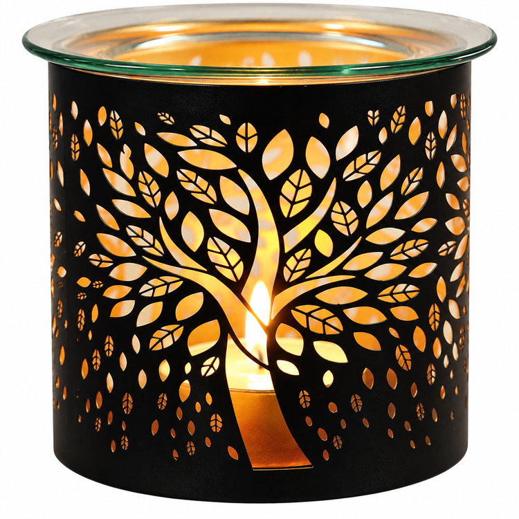 A black metal candle warmer with a laser-cut tree of leaves design, glowing with warm orange light from a tea light candle inside, set against a plain white background.