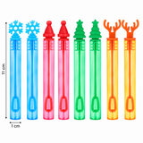 Eight colorful bubble wand tubes with decorative tops are shown on a white background, including blue snowflake, pink and red cone shapes, green Christmas tree shapes, and orange antler shapes. Measurement markings indicate 11 cm tube height and 1 cm wand length.