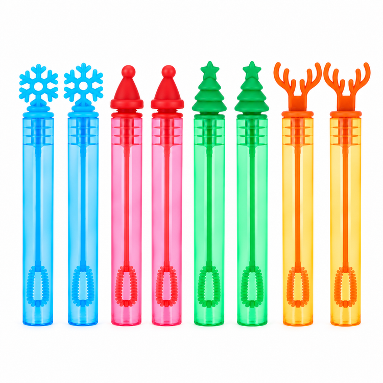Six colorful bubble wand tubes with festive tops arranged in a row on a white background. The designs include a blue snowflake, a red Santa hat, a pink Santa hat, a green Christmas tree, a green Christmas tree, and an orange reindeer antler.