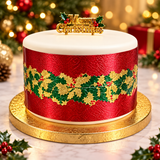 A round Christmas cake with white frosting on top, a textured red body, and a gold holly garland band around the middle. The cake sits on a gold cake board, with a 'Merry Christmas' topper on top.