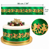 Green and gold holly ribbon shown with a width measurement of 86 cm (34 inches), a height measurement of 9 cm (3.5 inches), and a decorated cake example on a white background.