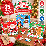 Three Christmas-themed wooden jigsaw puzzle boxes displayed on a wooden surface with loose puzzle pieces in front. The boxes feature festive holiday illustrations: Santa Claus with a reindeer, a penguin and snowman, and a gingerbread house.