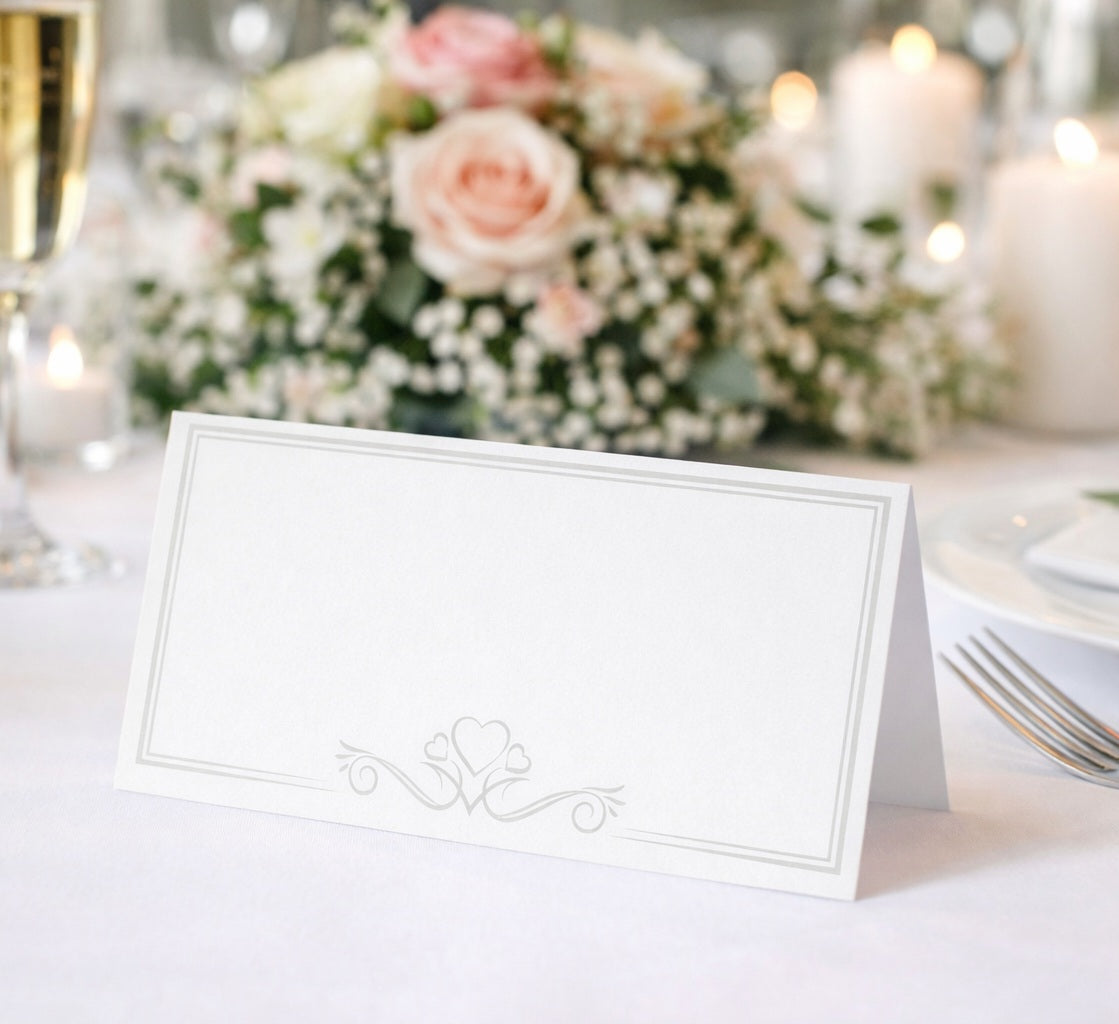Decorative place card on a table with flowers and candles in the background